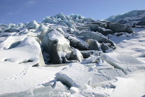 2003 Jeep TJ - A vast glacier landscape with jagged ice chunks and deep snow blankets under a bright sky.