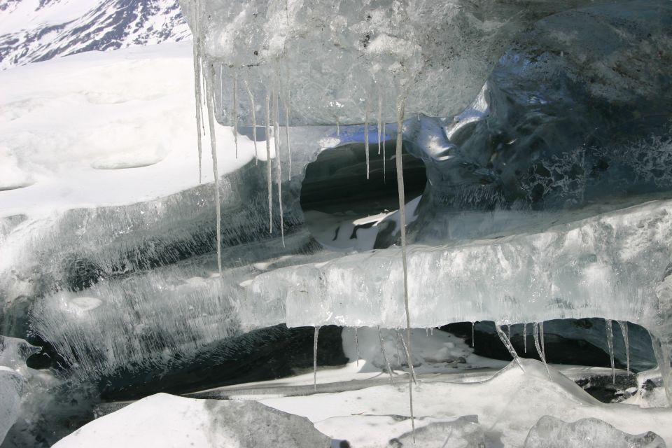 Ice cave opening with icicles hanging above and within