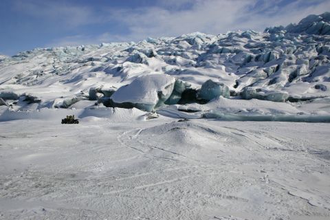 2003 Jeep TJ - A snowmobile travels across a glacier, with large ice formations in the background.