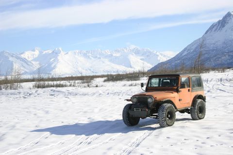 2003 Jeep TJ - 2003 Jeep TJ in a snowy mountain landscape.