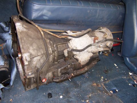 1987 Ford Bronco - Automatic transmission unit shown on the floor of a vehicle's interior.