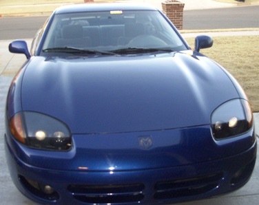 1994 Dodge Stealth - A blue Dodge Stealth is parked outside a brick building, viewed from the front.