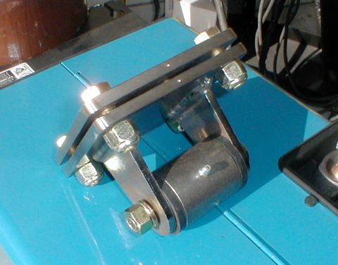 1996 Ford Bronco - A custom-fabricated metal bracket, likely for a vehicle project, is shown mounted on a blue surface.