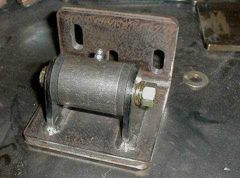 1996 Ford Bronco - Close-up view of a custom metal bracket assembly with a roller mechanism.