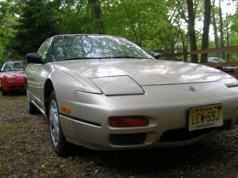 1992 Nissan 240SX - A silver 1992 Nissan 240SX is parked outdoors, with another red car visible behind it.