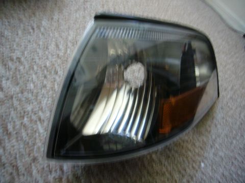 2000 Ford Crown Victoria - This is a close-up of a black corner light assembly that includes an amber turn signal indicator.
