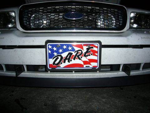 2000 Ford Crown Victoria - The front of a 2000 Ford Crown Victoria is shown, its grille and a D.A.R.E. license plate.