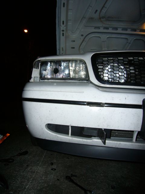 2000 Ford Crown Victoria - Front view of a 2000 Ford Crown Victoria, hood is open, revealing the engine bay.