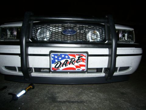 2000 Ford Crown Victoria - Front view of a white Ford Crown Victoria, equipped with a push bar and a D.A.R.E. license plate.