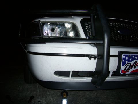 2000 Ford Crown Victoria - Front view of a white police car, a push bar and a license plate.