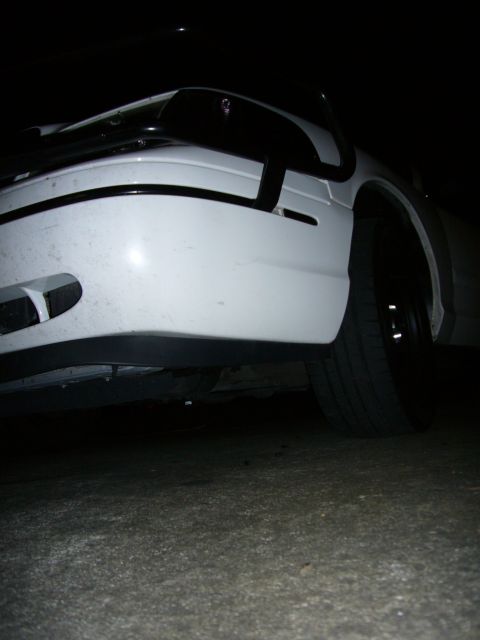2000 Ford Crown Victoria - Low angle shot of the front of a white 2000 Ford Crown Victoria at night.