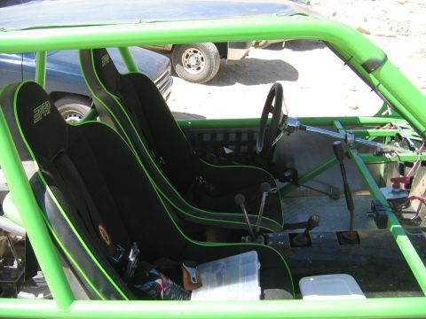 1985 Ford Bronco - Interior view of a custom buggy with racing seats and roll cage.