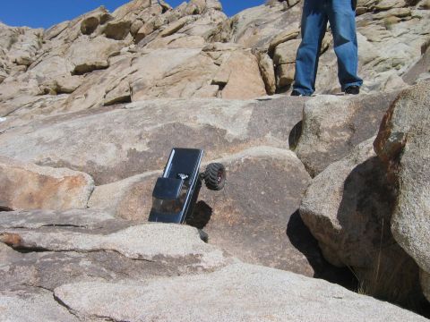 1985 Ford Bronco - A remote-controlled rock crawler navigates a challenging rocky landscape.