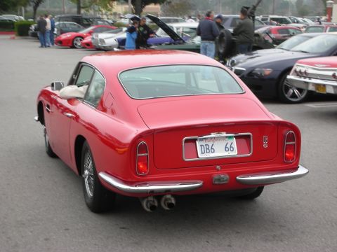 1998 Ford Crown Victoria - A red coupe is parked in a lot with several other vehicles visible in the background.