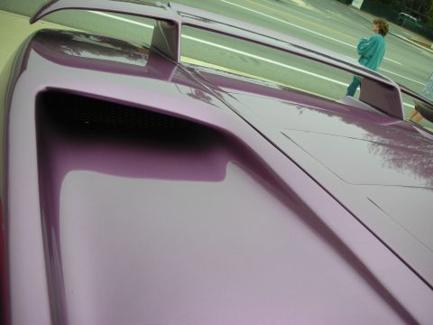 1998 Ford Crown Victoria - A custom purple car with a prominent rear spoiler and a functional-looking hood scoop is seen from a high angle.