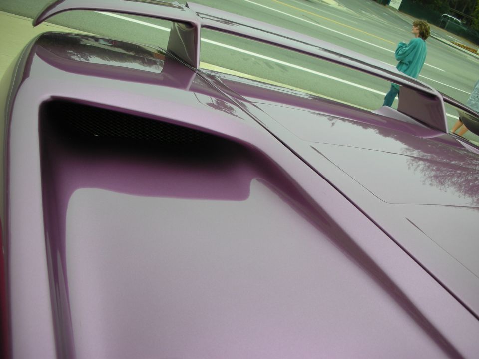Close-up of a purple sports car rear wing scoop and engine vent