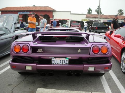 1998 Ford Crown Victoria - Purple Lamborghini Diablo parked at a car meet, with a red Ferrari nearby.