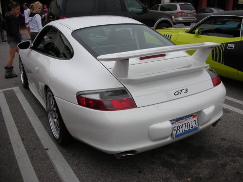 1998 Ford Crown Victoria - A white Porsche 911 GT3 is seen from the rear, parked next to other vehicles at a coffee meet.