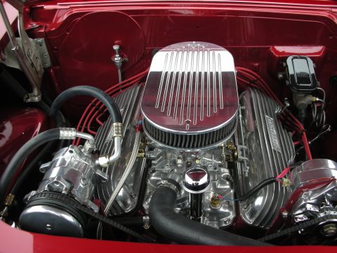 1998 Ford Crown Victoria - Close-up of a custom V8 engine with chrome components and red paint.