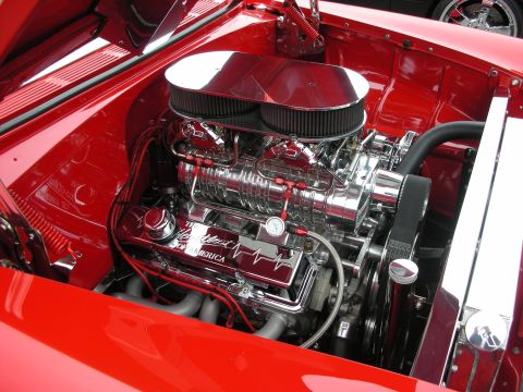1998 Ford Crown Victoria - A highly polished V8 engine with a prominent supercharger and dual air filters is displayed in a red engine bay.