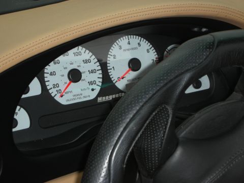 1998 Ford Crown Victoria - Interior view of a car's dashboard, highlighting the speedometer and tachometer with 'Manguesta' branding.
