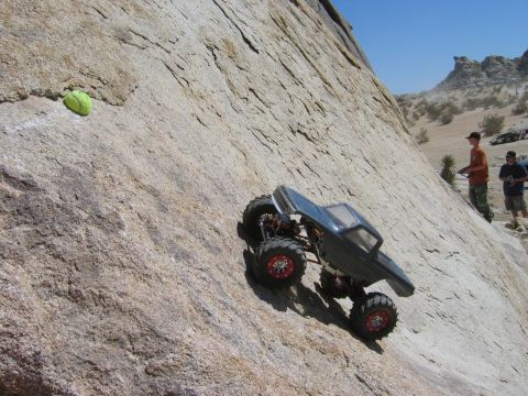 1985 Ford Bronco - A remote control rock crawler navigates a challenging ascent on a large rock formation.