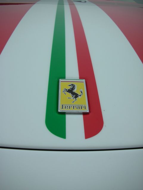 1998 Ford Crown Victoria - Ferrari badge on a white car hood with Italian flag racing stripes.