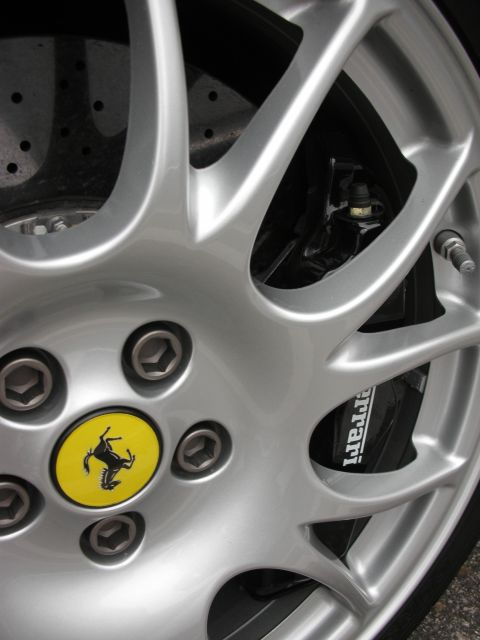 1998 Ford Crown Victoria - A close-up view of a silver alloy wheel and black brake caliper with the Ferrari logo and name visible.
