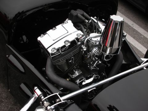 1998 Ford Crown Victoria - Close-up of a polished V-twin motorcycle engine with chrome accents and black exhaust.