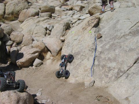 1985 Ford Bronco - RC rock crawlers navigate a challenging off-road course with steep inclines and large boulders.