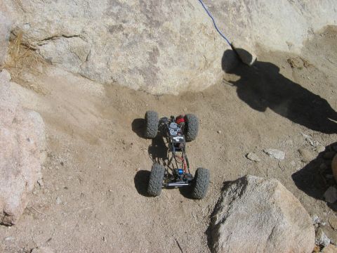1985 Ford Bronco - A remote control rock crawler navigates a rocky, sandy obstacle course.
