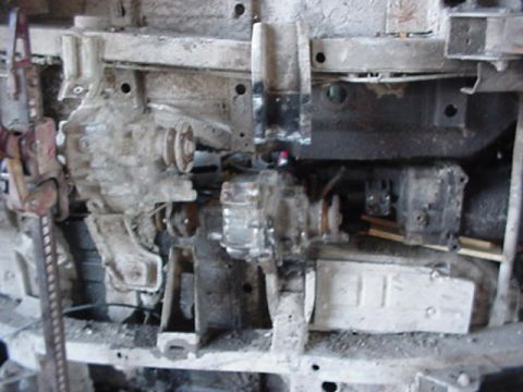 1992 Ford Bronco - Close-up of a vehicle's undercarriage, focusing on the dual transfer case assembly.