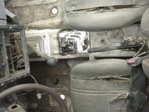 1992 Ford Bronco - The interior of an older vehicle is shown, focusing on the dashboard and dual shifter setup.