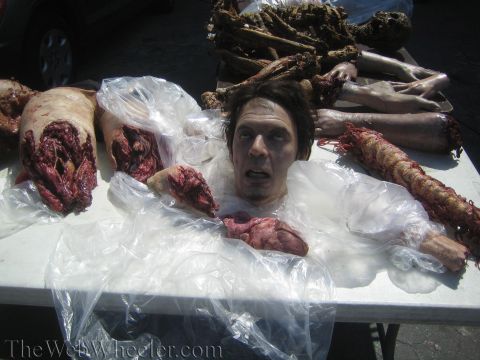 1990 Ford Bronco - Photo of Halloween special-effects body-part and head props arranged on a table outdoors.