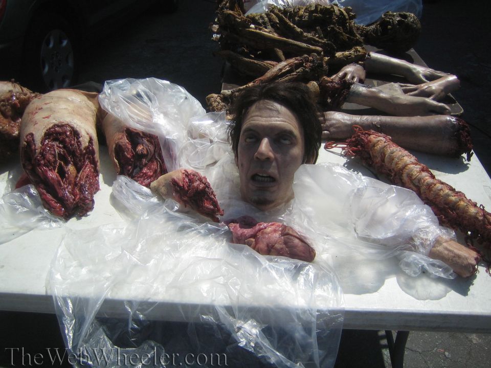 Halloween special-effects severed body parts and head props on a folding table