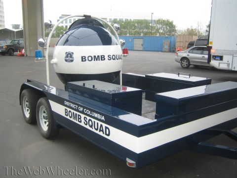 1990 Ford Bronco - District of Columbia Bomb Squad trailer carrying a navy-and-white spherical bomb containment sphere and storage boxes.