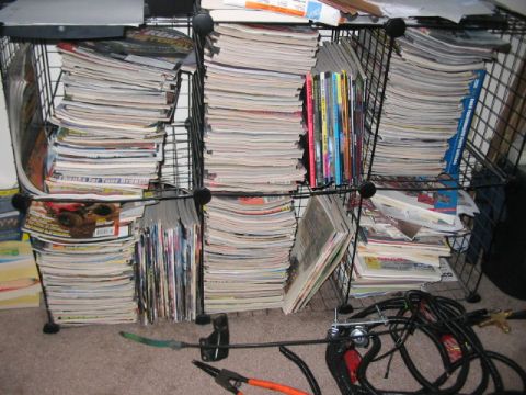 1991 Ford Bronco - Organized storage units overflowing with reading material, with tools scattered nearby.