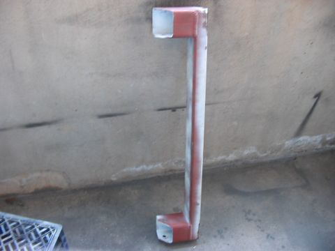 1991 Ford Bronco - A painted metal pipe structure is shown against a concrete wall.