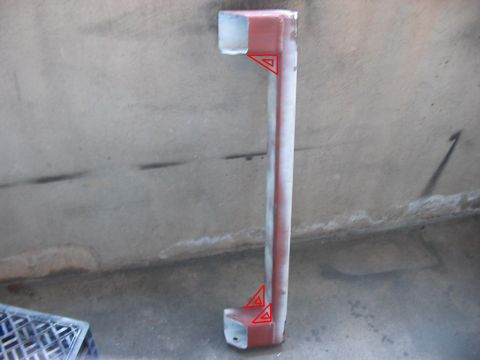 1991 Ford Bronco - A metal pipe with red markings is shown against a concrete wall.