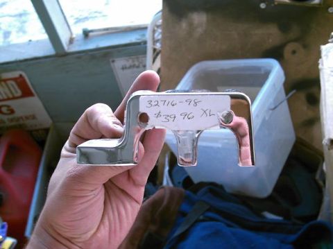 1986 Ford Bronco - A hand holds a chrome part with a handwritten tag showing part number 32716-98 and price $39.96 XL.