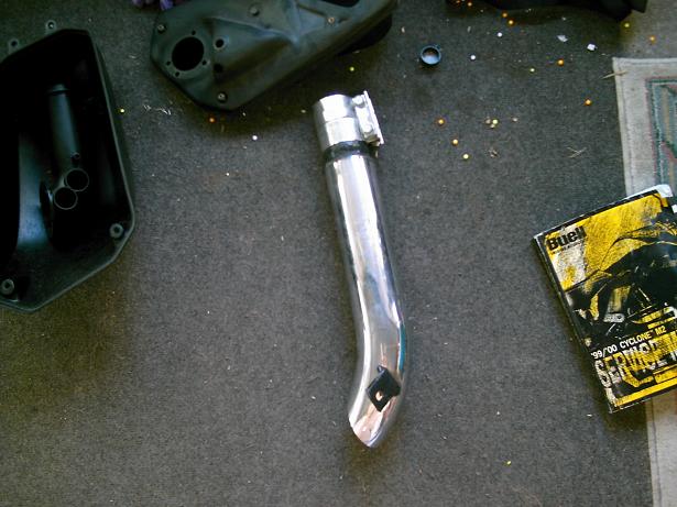 Chrome exhaust pipe next to Buell service manual
