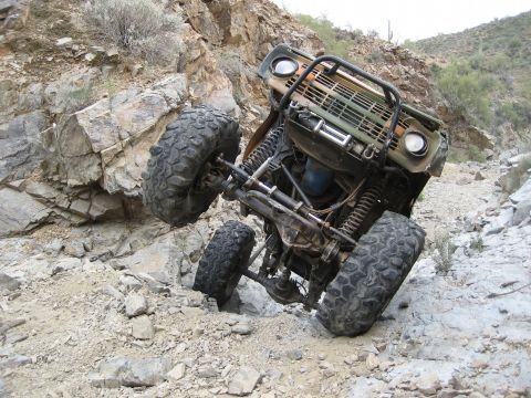 1966 Ford Bronco - Modified 1966 Ford Bronco navigating a challenging off-road trail.