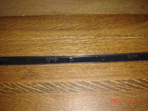 1993 Ford Bronco - Black plastic trim piece shown on a wooden surface.