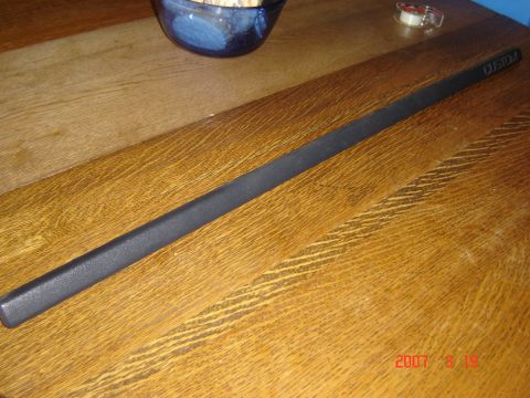 1993 Ford Bronco - A black trim piece labeled "CUSTOM" is shown on a wooden surface.