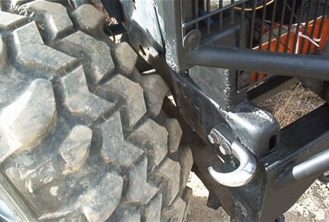 1986 Ford Bronco - Detail of an off-road tire and custom metalwork, possibly for a truck or SUV.