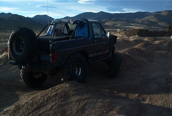 1986 Ford Bronco rear 3/4 view on dirt terrain