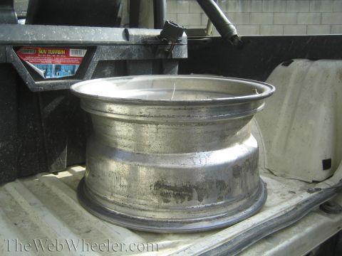 1968 Ford Mustang - An aluminum wheel is visible in the bed of a pickup truck, next to a Contico SUV Tuffbin.