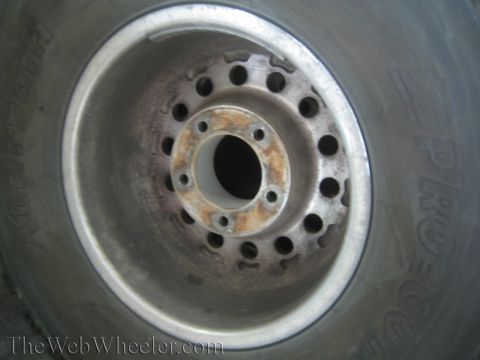 1968 Ford Mustang - Close-up of a vehicle wheel and tire, showing the lug nut pattern and tire sidewall text.