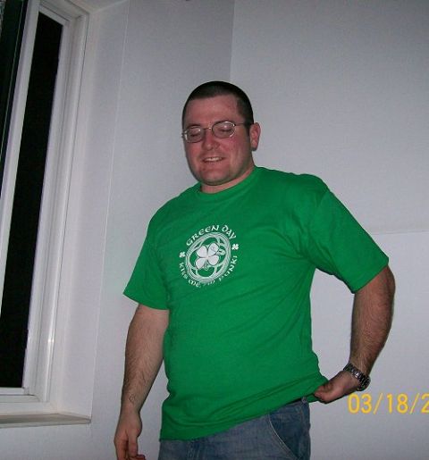 1990 Ford Bronco - Man wearing a green t-shirt with a shamrock and "Green Day" text.