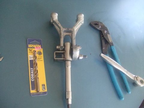 1995 Ford Mustang - Tools and an automotive component are laid out on a blue surface, suggesting a repair or assembly process.
